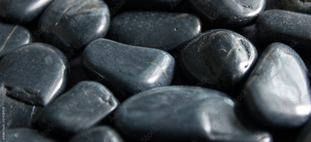 Background from black, decorative stones. Backdrop with copy space.