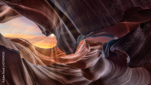 Sunlight shines through the narrow rock walls of Antelope canyon in Arizona. Abstract, art and background concept. Travel and holiday concept.