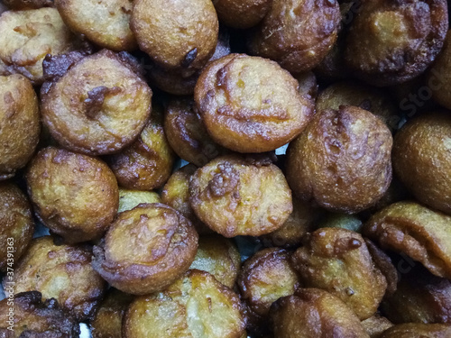 Kerala traditional style soft puffy sweet unni appam placed in a steel plate after being fried in hot boiled coconut oil  photo