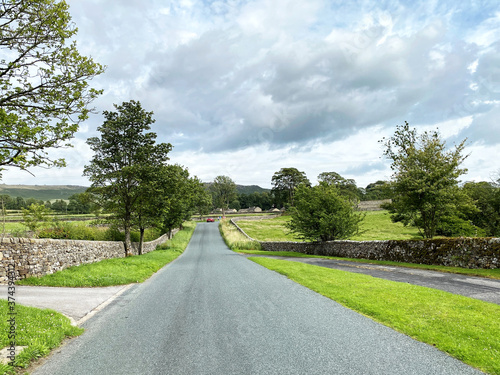 Looking down the road, toward Rylstone, as you leave Hetton village, on a bright day in, Hetton, Skipton, UK