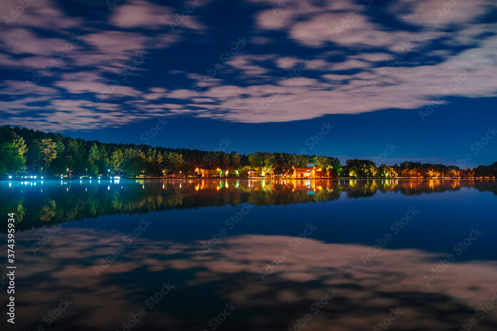 Moscow. August 27, 2020. Meshchersky pond. Beautiful night landscape with reflection of clouds on the surface of the water.