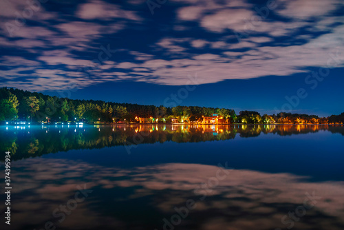 Moscow. August 27, 2020. Meshchersky pond. Beautiful night landscape with reflection of clouds on the surface of the water. © fotiy