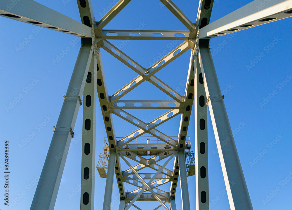 metal structures of the railway bridge against the blue sky metal structures of the railway bridge against the blue sky