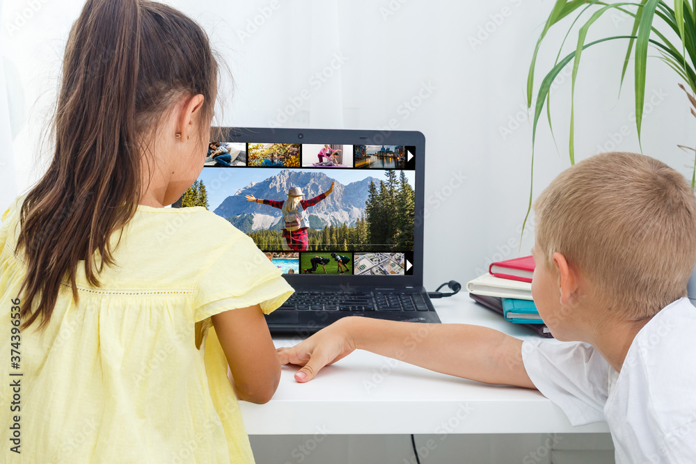 home, leisure, technology and internet concept - little student girl with laptop computer at home