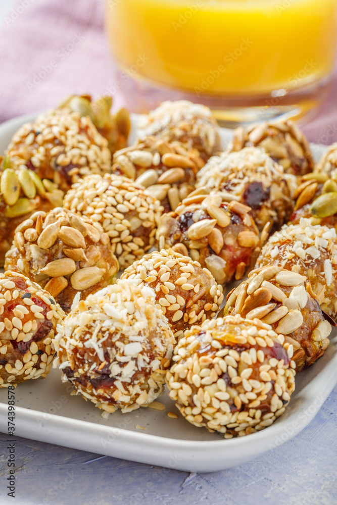 energy protein balls made with dry apricots, raisins, dates, walnuts, sunflower seeds, pumpkin seeds, sesame