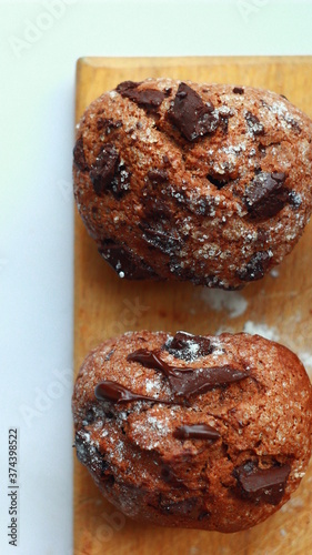 Chocolate muffins closeup on wooden boards