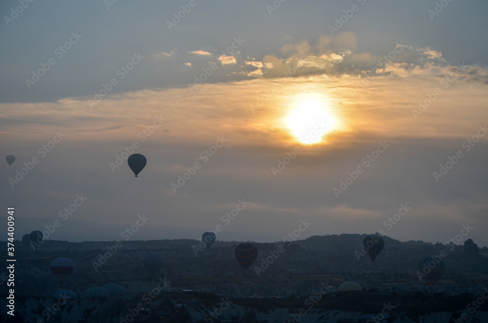Colorful hot air balloons flying over mountains landscape and the valley at Cappadocia in the sunrise sky at foggy morning
Colorful hot air balloons flying over mountains landscape and the valley at Cappadocia in the sunrise sky at foggy morning
