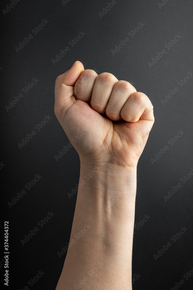 Woman clenched fist. Concept of unity, fight or cooperation Woman clenched fist. Concept of unity, fight or cooperation