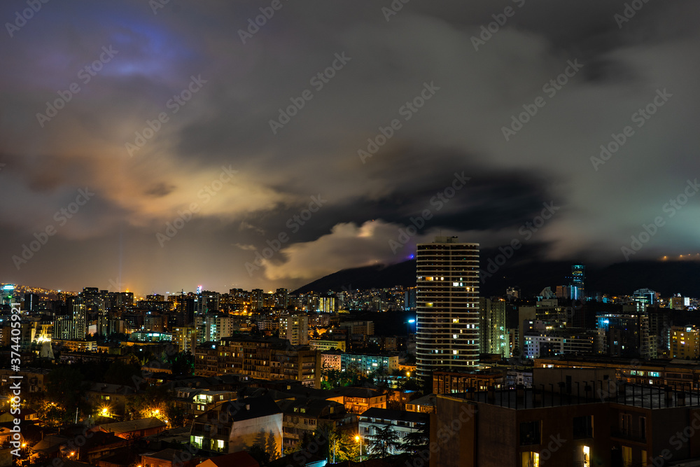 Dramatic night sky over Tbilisi city