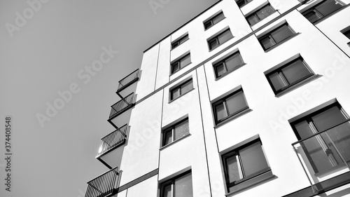 Detail of modern residential flat apartment building exterior. Fragment of new luxury house and home complex. Black and white.