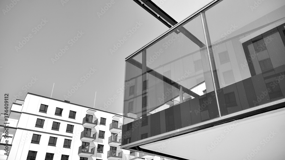 Fototapeta premium Detail of modern residential flat apartment building exterior. Fragment of new luxury house and home complex. Black and white.