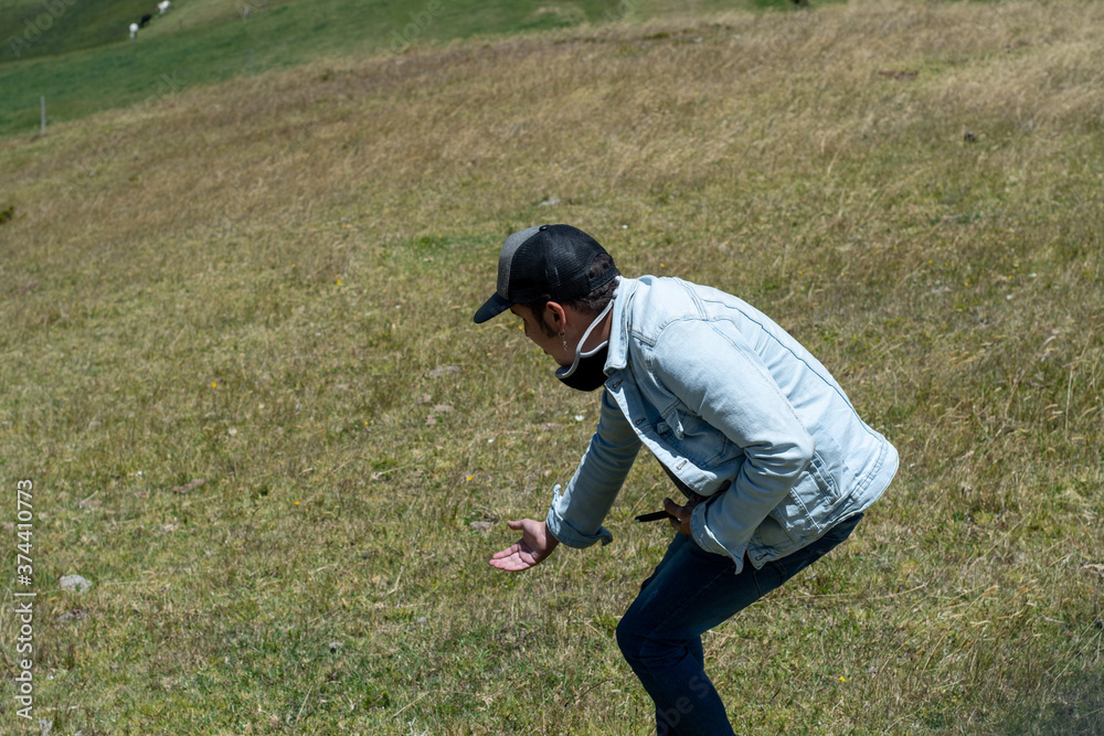 men climbing a big yellow mountain with a blue sky and green fields in the back ground men climbing a big yellow mountain with a blue sky and green fields in the back ground