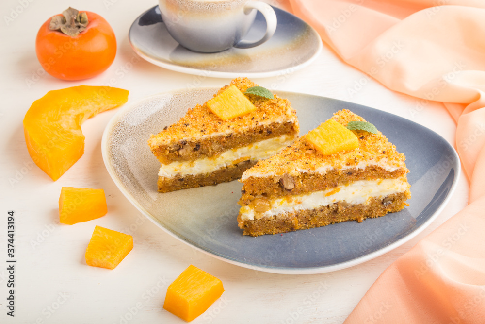 Homemade cake with persimmon and pumpkin and a cup of coffee on a white wooden background with orange textile. side view, close up. Homemade cake with persimmon and pumpkin and a cup of coffee on a white wooden background with orange textile. side view, close up.