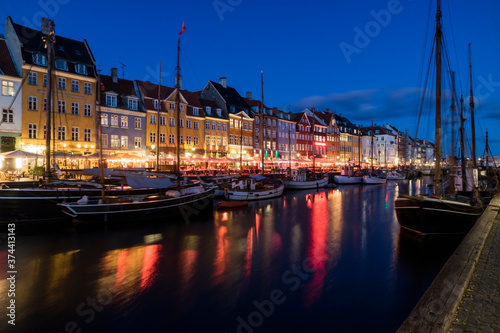 Nyhavn water front canal and touristic street at night photo