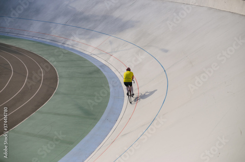 Kyiv, Ukraine 27.08.2020 - A man rides a bicycle on a track stadium