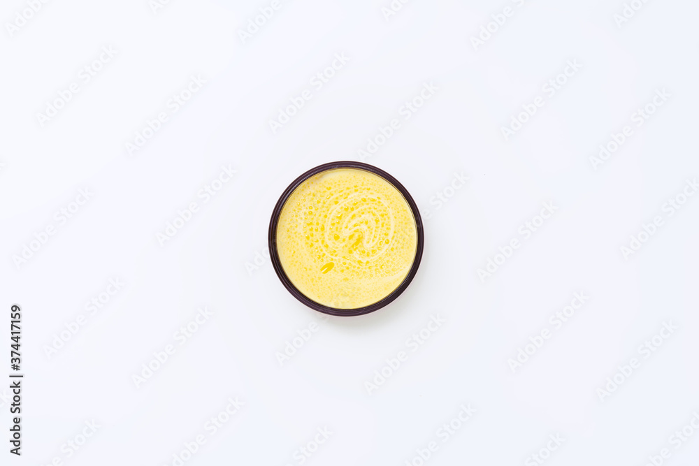 Black jar with yellow cream with sea buckthorn oil on a white background. Black jar with yellow cream with sea buckthorn oil on a white background.