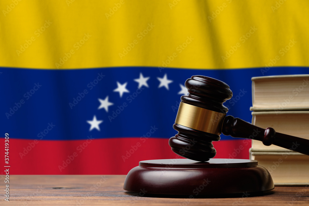 Justice and court concept in Bolivarian Republic of Venezuela. Judge hammer on a flag background