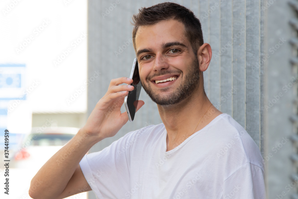 attractive young man with mobile phone on the street attractive young man with mobile phone on the street