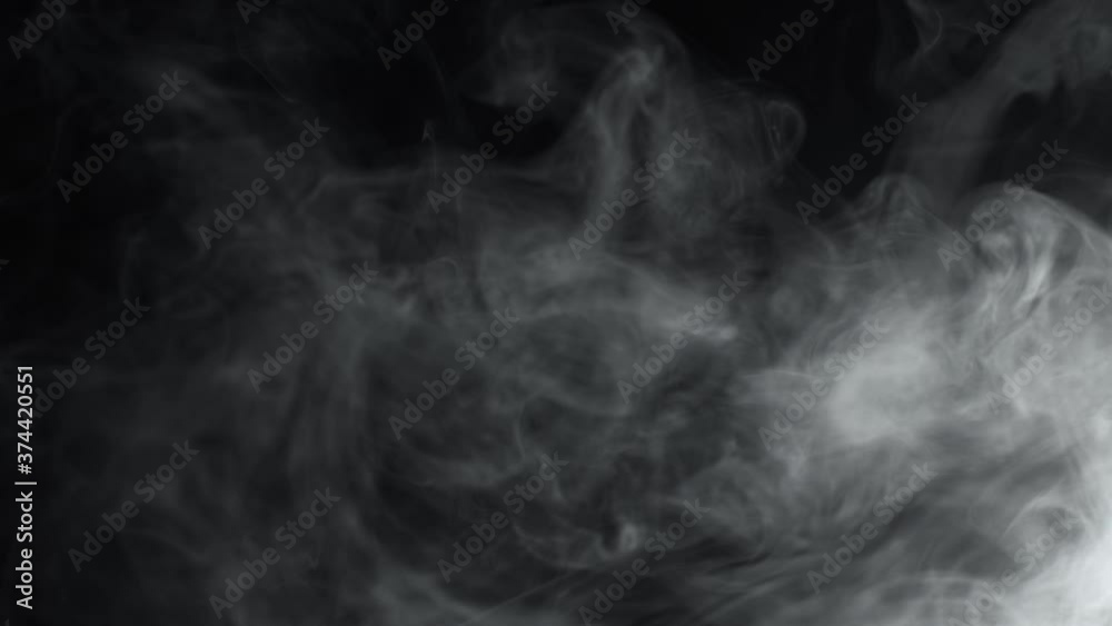 Smoke On Black Background. Gray Smoke Guickly Pours In Portions. Smoke On Black Background. Gray Smoke Guickly Pours In Portions.