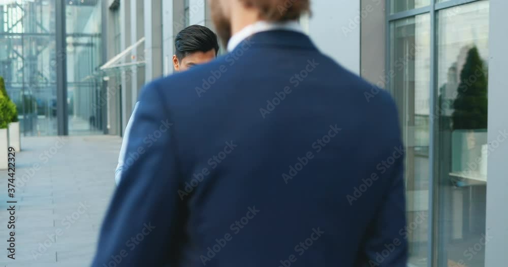 Young sad Hindu man, white-collar worker walking the street and carrying box with stuff after being fired. Upset Office manager dismissed from work. Economic crisis of unemployment. Firing from job. Young sad Hindu man, white-collar worker walking the street and carrying box with stuff after being fired. Upset Office manager dismissed from work. Economic crisis of unemployment. Firing from job.