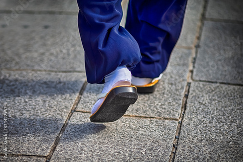 Closeup of Japanese Monk in traditional Sabo Walking on Street in Kyoto