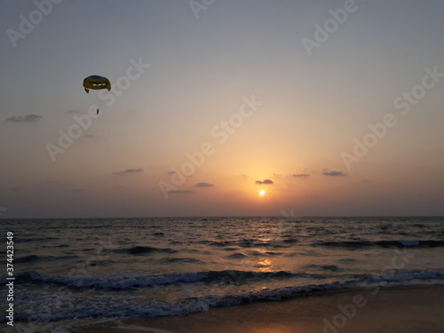 Parasailing in Goa at sunset. sunset over the sea. sunset at the beach. Goa beach. 
