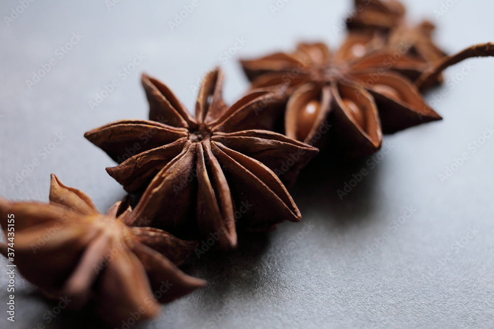 Fragrant star anise stars on a gray concrete countertop Fragrant star anise stars on a gray concrete countertop