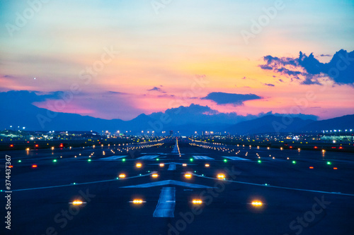 Airfield ground lighting on runway, sunrise time at Hong Kong Airport