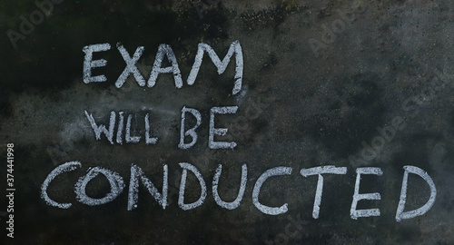 Exam Will Be Conducted Phrase Written on Blackboard with Chalk