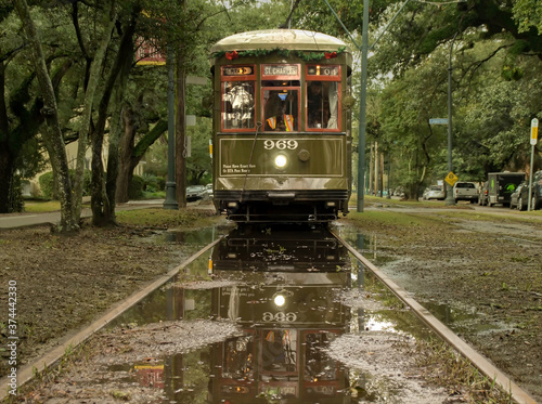 Old New Orleans streetcar reflected in rain puddle