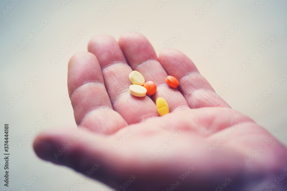 hand of an adult man with pills hand of an adult man with pills