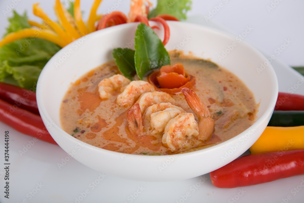 Tom Yam kung Spicy Thai soup with shrimp, seafood, coconut milk and chili pepper in bowl copy space Tom Yam kung Spicy Thai soup with shrimp, seafood, coconut milk and chili pepper in bowl copy space