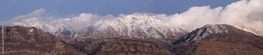 Long panorama of Mount Timpanogos shrouded in low lying clouds