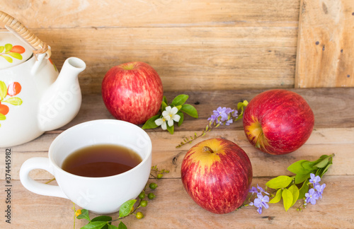 background texture super fruits red apple healthy foods for diet and hot tea with flower arrangement flat lay style on wooden