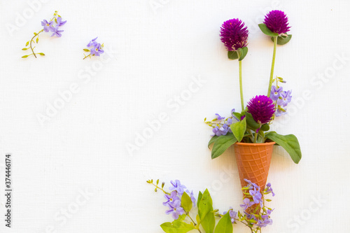 colorful flowers amaranth with purple little flowers local flora of asia arrangement in cone flat lay postcard style on background white wooden