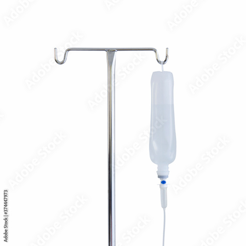 Saline container hanging in a hospital steel column isolated on white background.