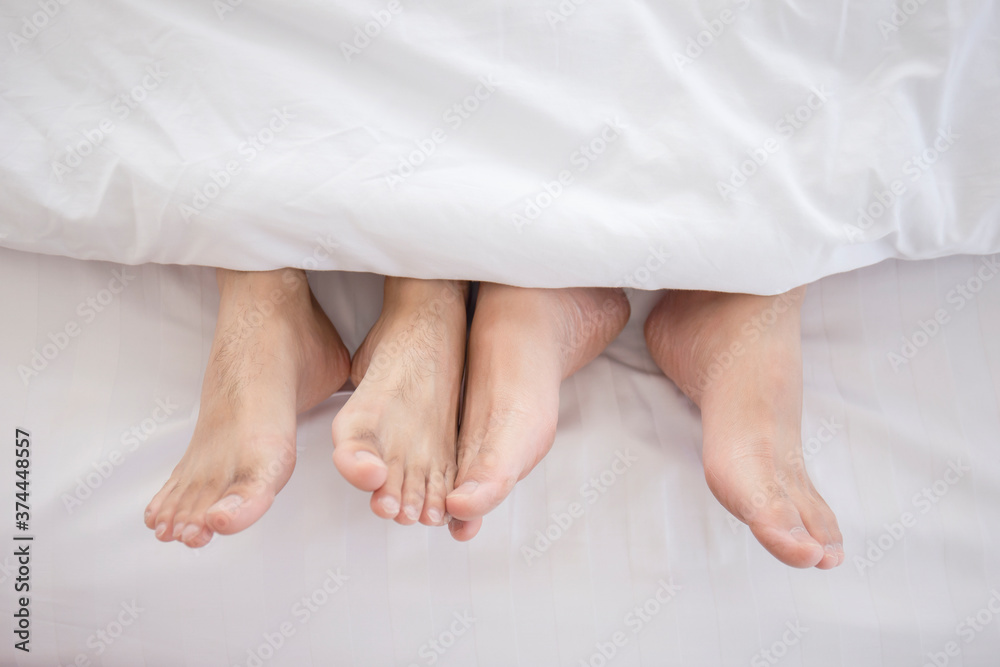 Close up of two men's feet on the bed LGBT concept.