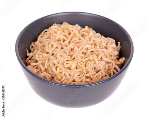 Asian instant noodle in dark bowl, isolated on white background.