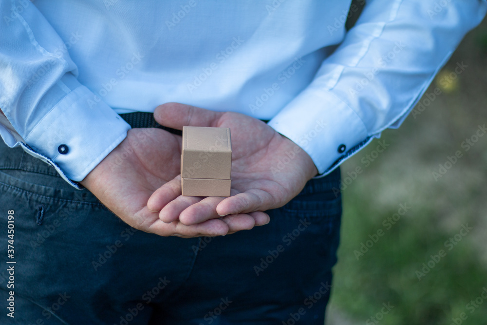 engagement ring box hidden behind him engagement ring box hidden behind him