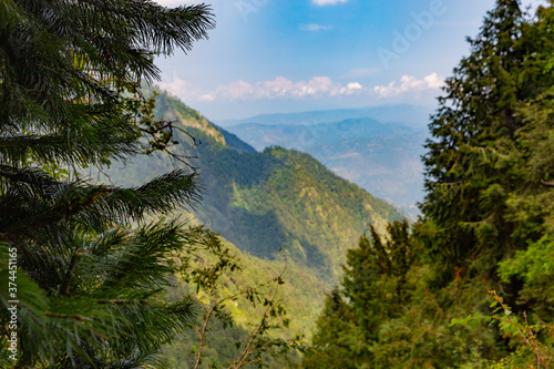 lush green mountains with. white clouds and blue sky from pipeline track murree