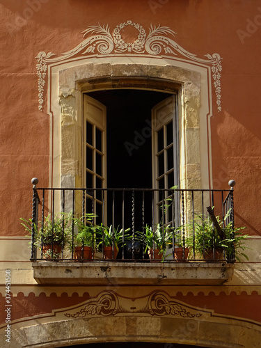 Detail of Baroque balcony decorated by sgraffito. Old city center of Tarragona. Catalonia. Spain. 