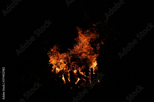 the flame of a burning campfire on a black background