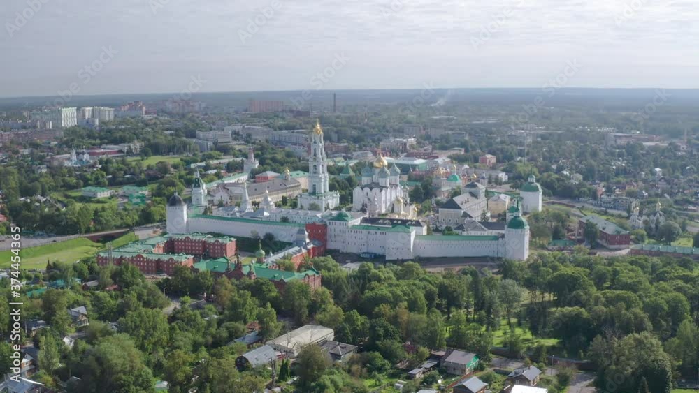 Scenic cinematic aerial view of Trinity Lavra of St. Sergius in Sergiyev Posad in Moscow oblast in Russian Federation. Beautiful summer sunny look of ancient orthodox monastery in old town Scenic cinematic aerial view of Trinity Lavra of St. Sergius in Sergiyev Posad in Moscow oblast in Russian Federation. Beautiful summer sunny look of ancient orthodox monastery in old town