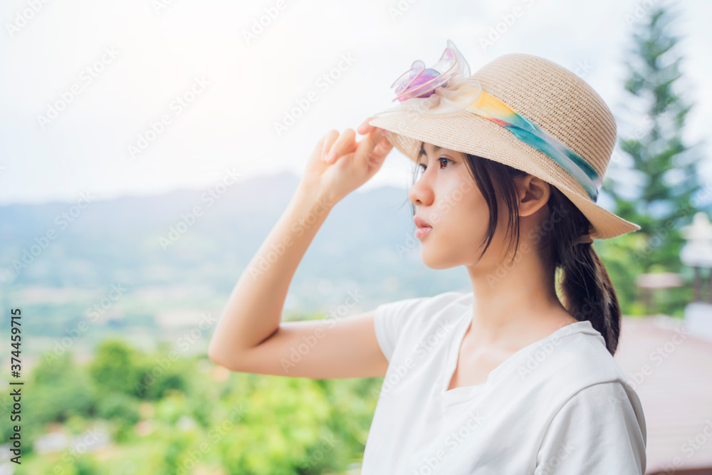 Asian attractive young woman traveler tourist hiking wearing hat standing silhouette looking at mountain nature landscape view scenery, hot summer wearing hat feeling peaceful joyful happy harmony