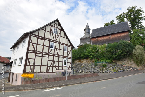 Fachwerkhaus und historische Dorfkirche in Hessen photo