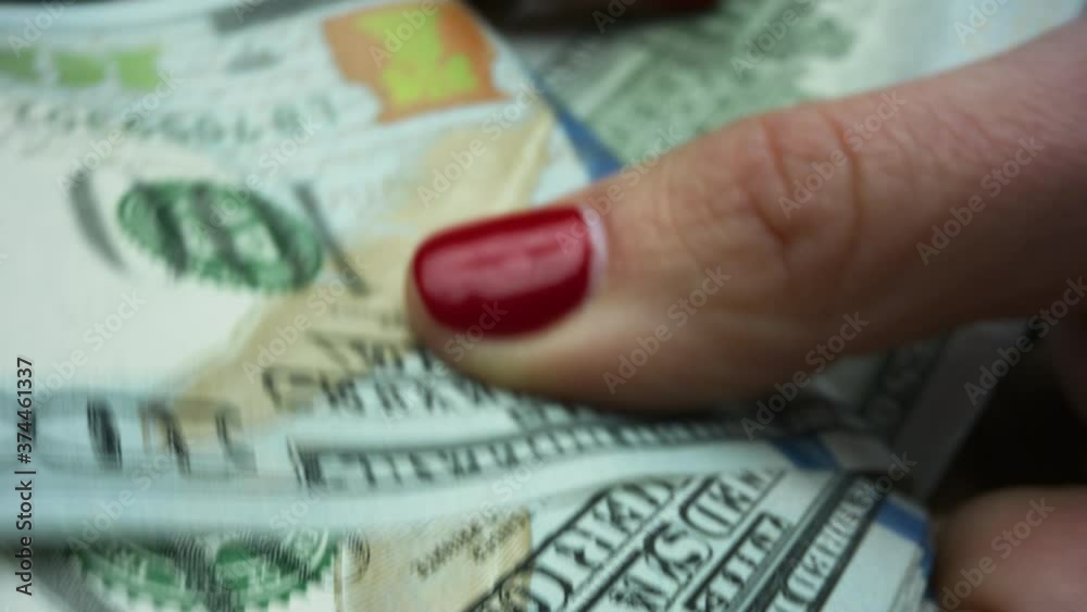 Businesswoman hands holding US money banknotes of new 100 dollars Businesswoman hands holding US money banknotes of new 100 dollars