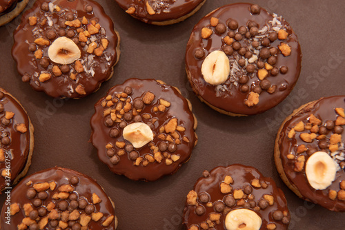 Brown Isler (or Ischler, Ishler) Cookies with hazelnuts and peanut brittle on brown background, dating back to Austro-Hungarian Empire