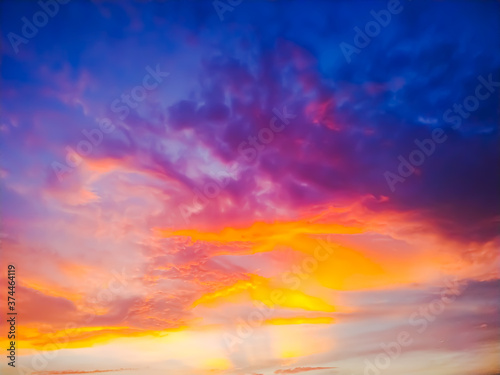 sunset sky with clouds explosion and golden light at ocean ,long exposure
