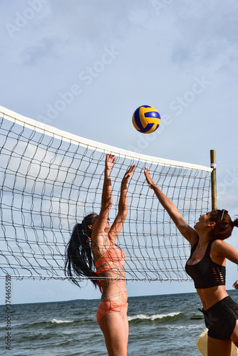 Asian Beautiful woman in bikini swimwear playing beach volleyball  for healthy active lifestyle/enjoying sport on summer holiday vacation concept