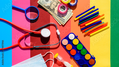 School supplies and protective mask during classes on a colorful and cheerful background.